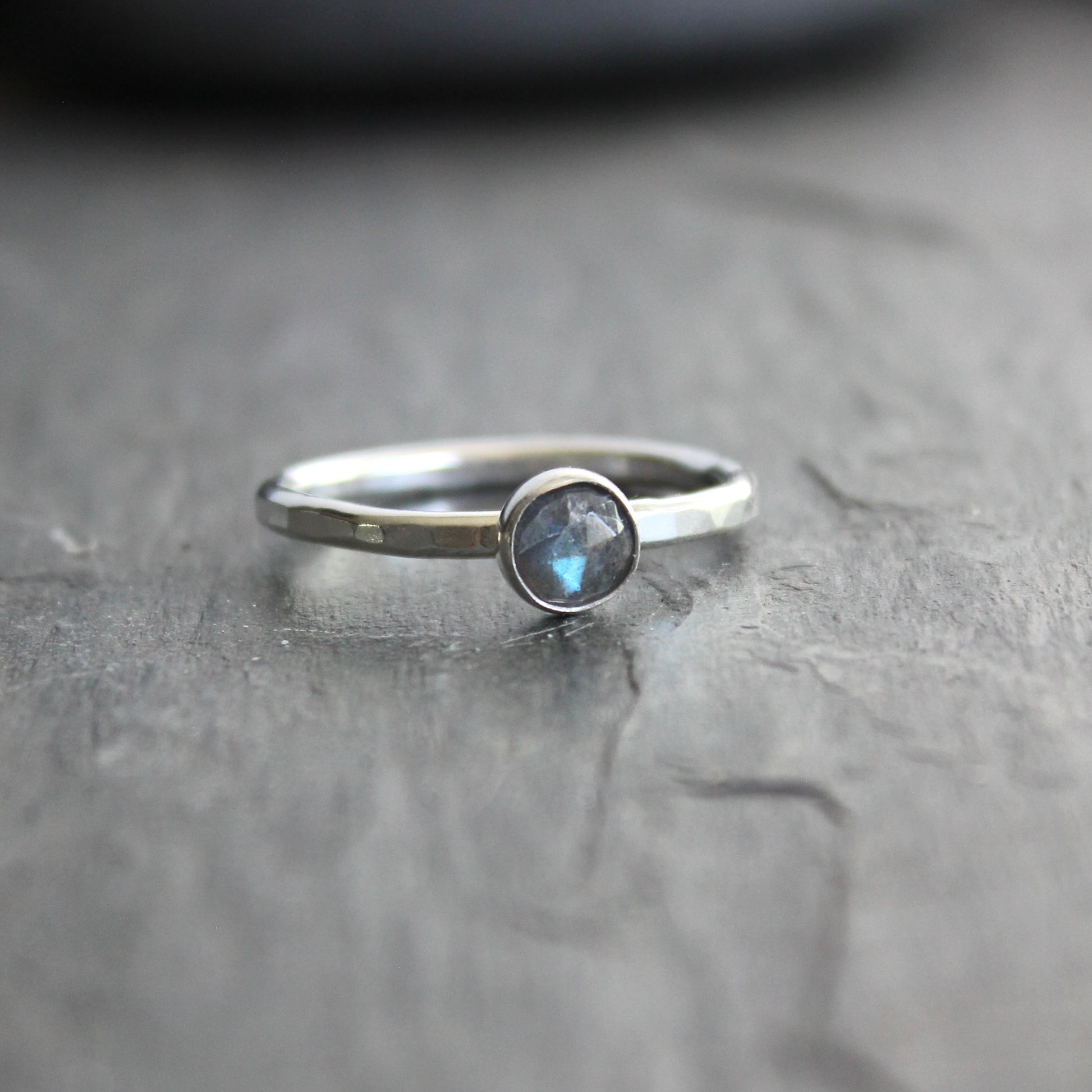 This stackable ring has a 6mm rose cut labradorite cabochon set in a sterling silver bezel on a sturdy hammered band. Available in any size. 