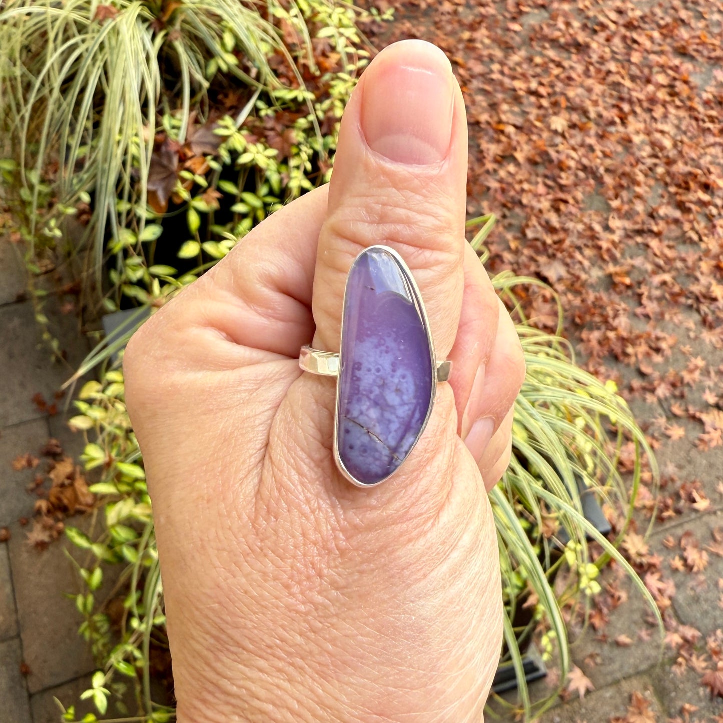 Hand wearing a ring with a holley blue agate