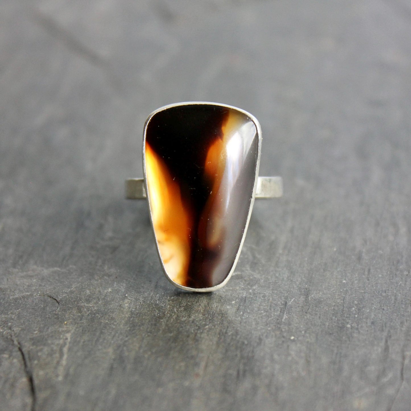 This ring has a large Montana agate cabochon set in a fine and sterling silver bezel setting on a sturdy hammered band. Handmade by Will Macy in Corvallis, OR.