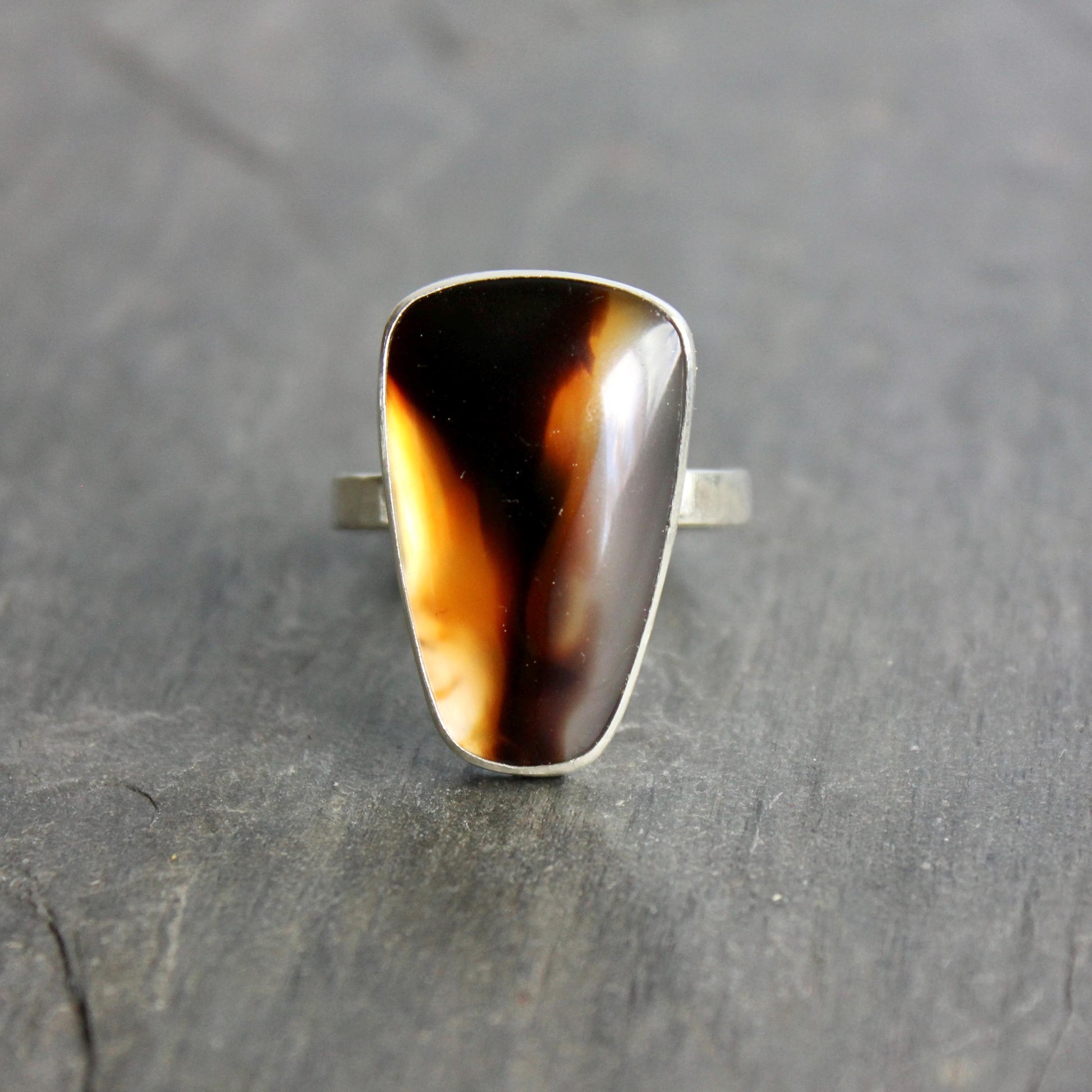 This ring has a large Montana agate cabochon set in a fine and sterling silver bezel setting on a sturdy hammered band. Handmade by Will Macy in Corvallis, OR.