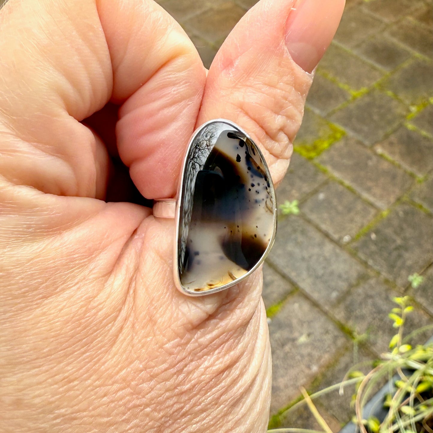 large montana agate ring on a thumb