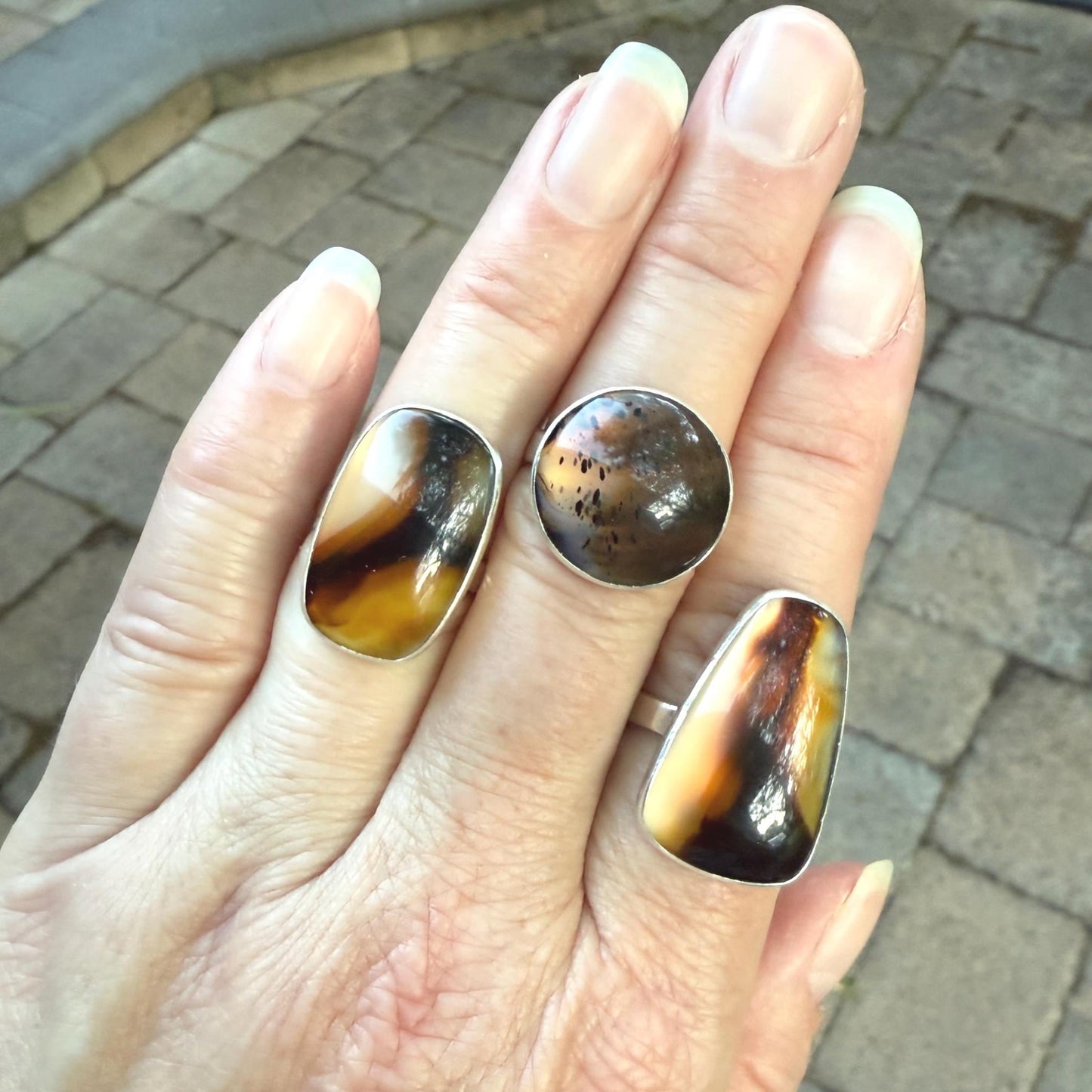This pretty ring has a splotchy round Montana agate cabochon set in a fine and sterling silver bezel setting on a sturdy hammered band. Handmade by Will Macy in Corvallis, OR. Size 8 1/2