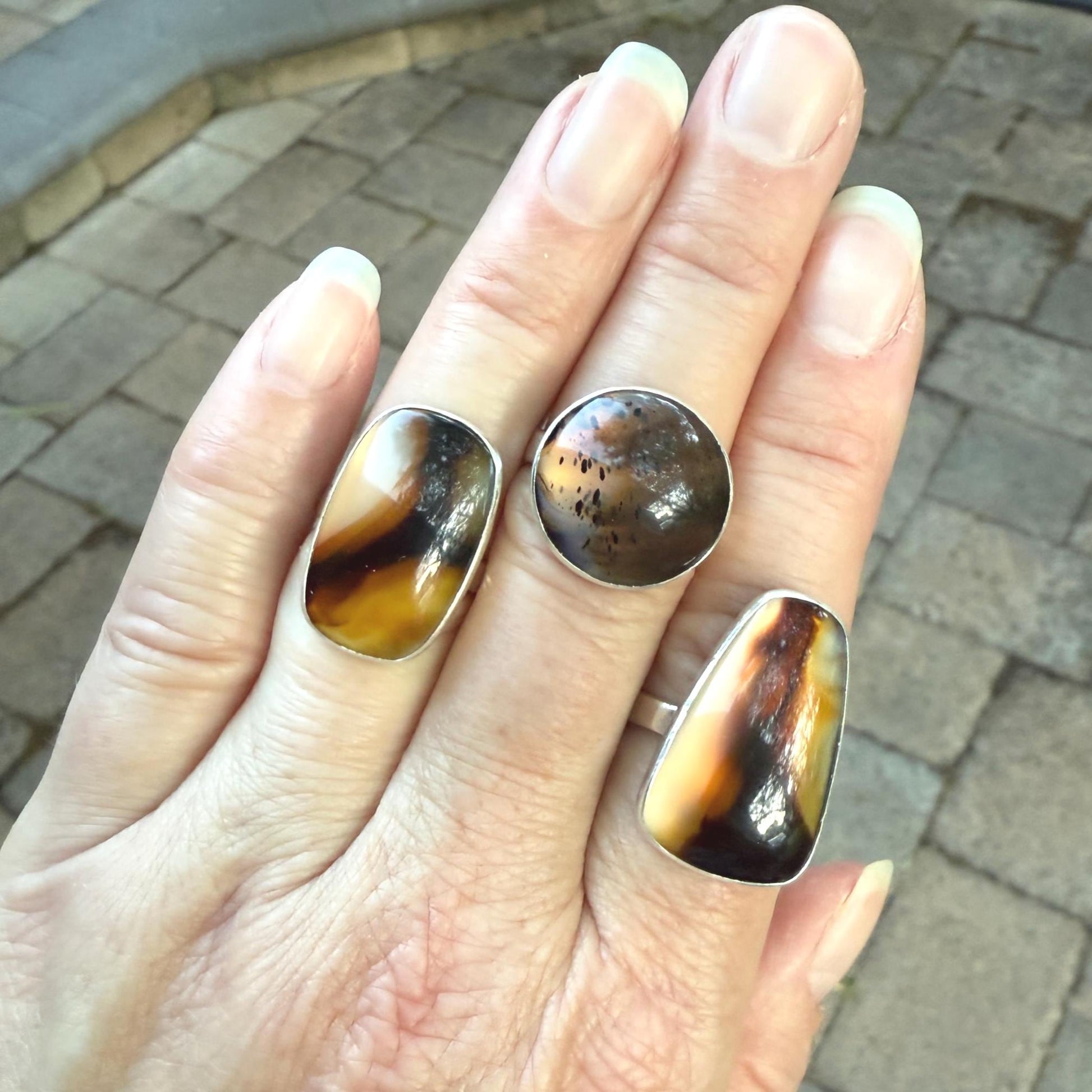 This pretty ring has a splotchy round Montana agate cabochon set in a fine and sterling silver bezel setting on a sturdy hammered band. Handmade by Will Macy in Corvallis, OR. Size 8 1/2