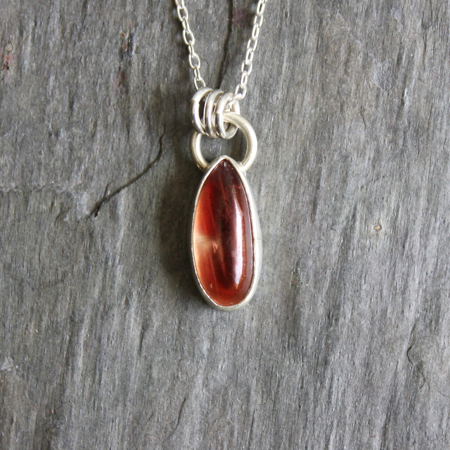 Necklace with an oregon sunstone pendant on a stone surface