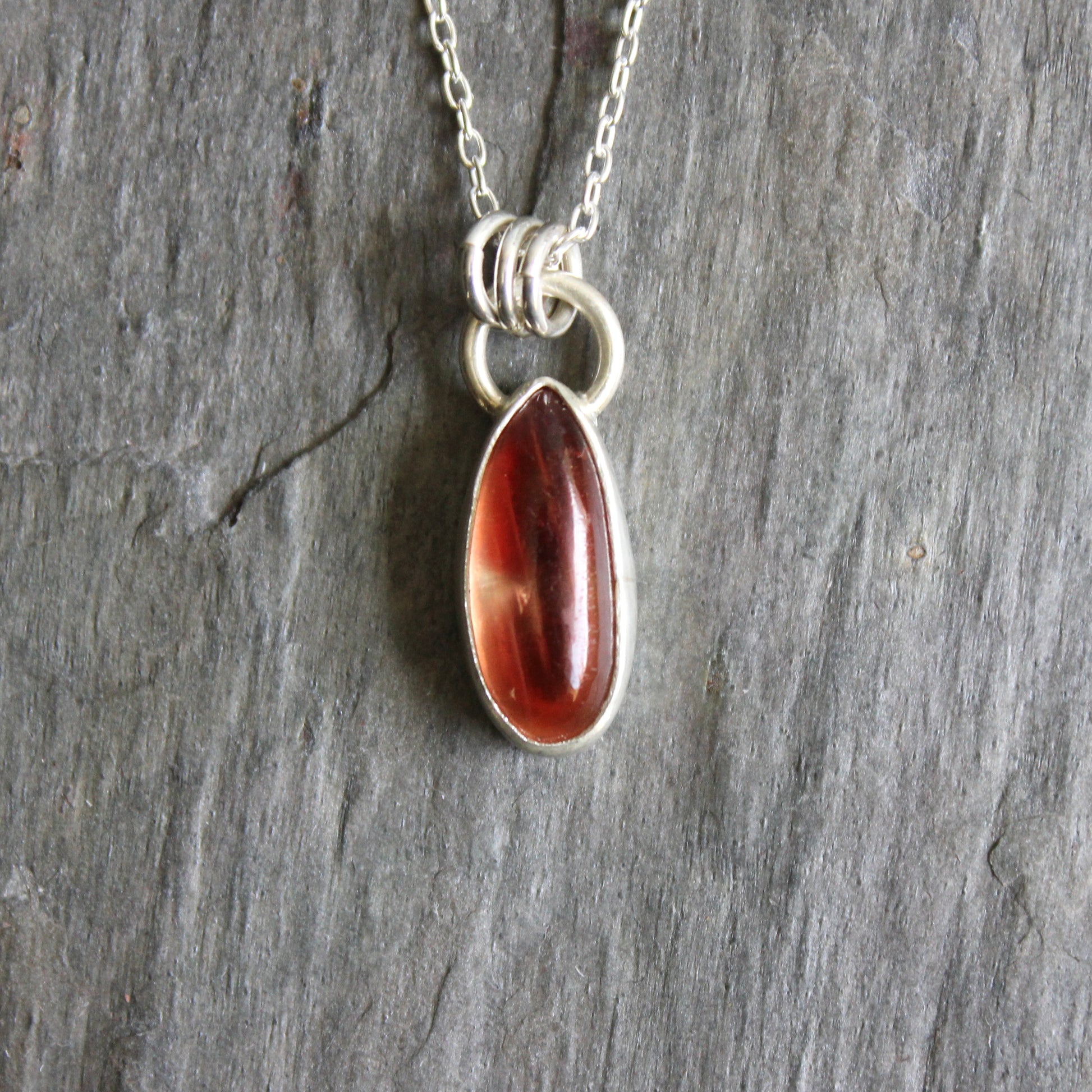 Necklace with an oregon sunstone pendant on a stone surface