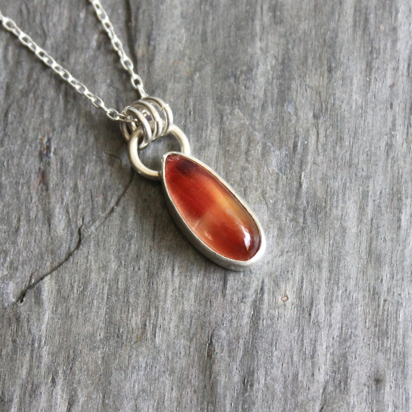 Necklace with an oregon sunstone pendant on a stone surface