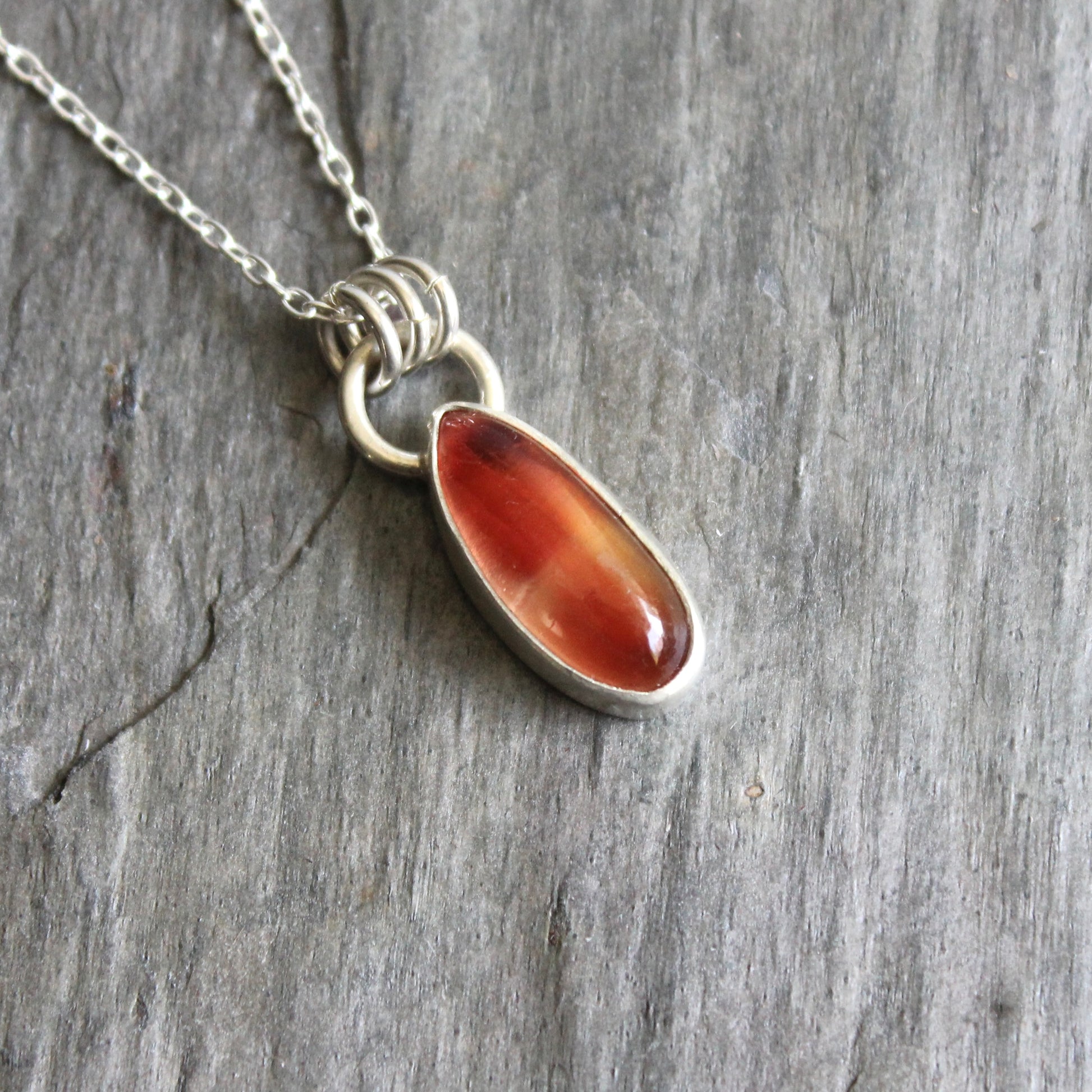 Necklace with an oregon sunstone pendant on a stone surface