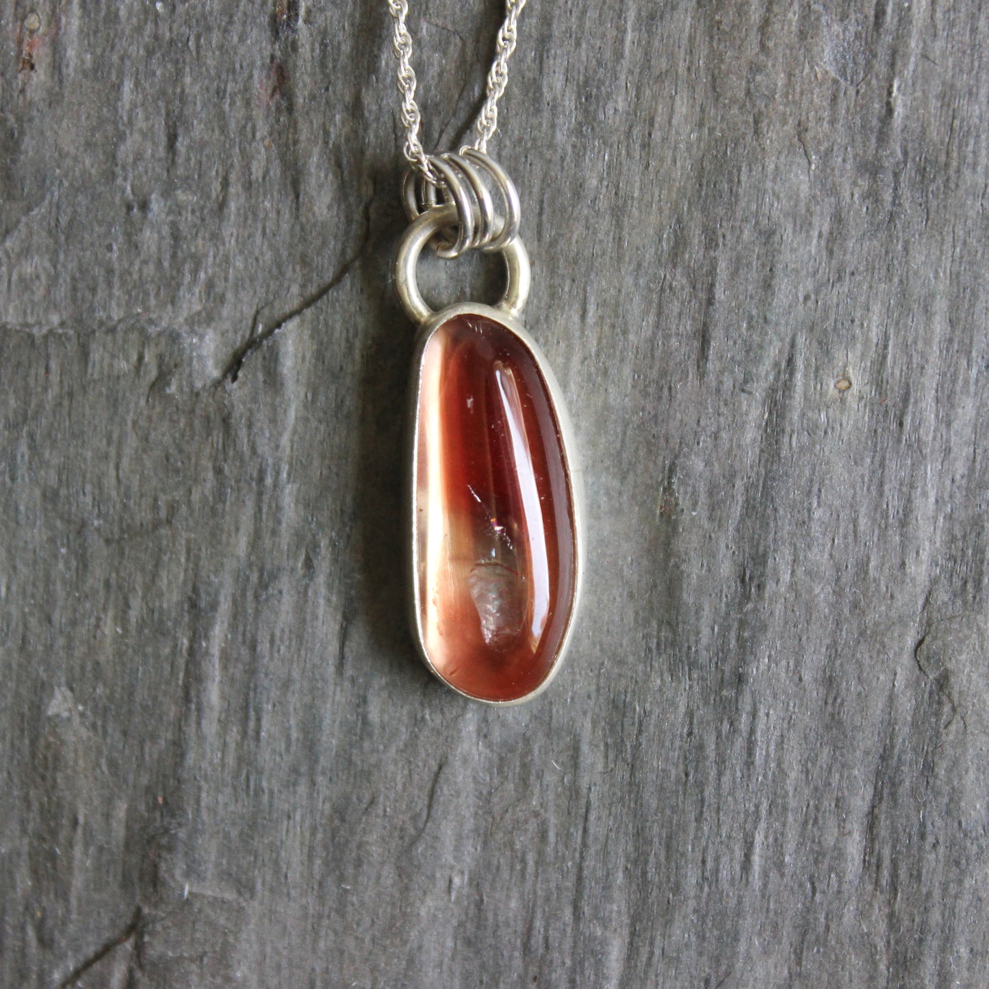 Necklace with an oregon sunstone pendant on a stone surface