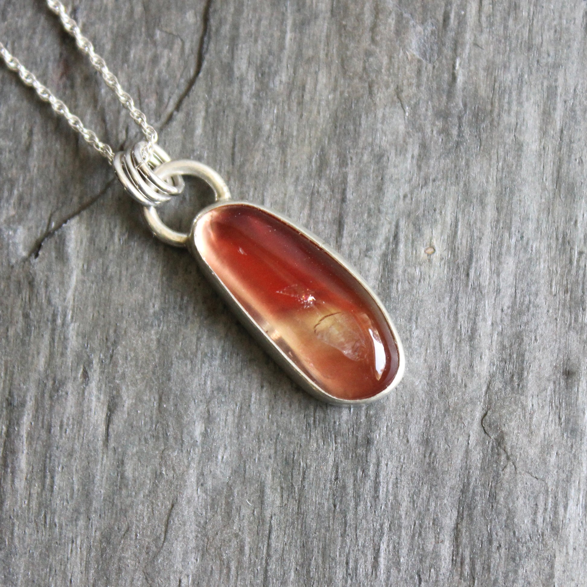 Necklace with an oregon sunstone pendant on a stone surface