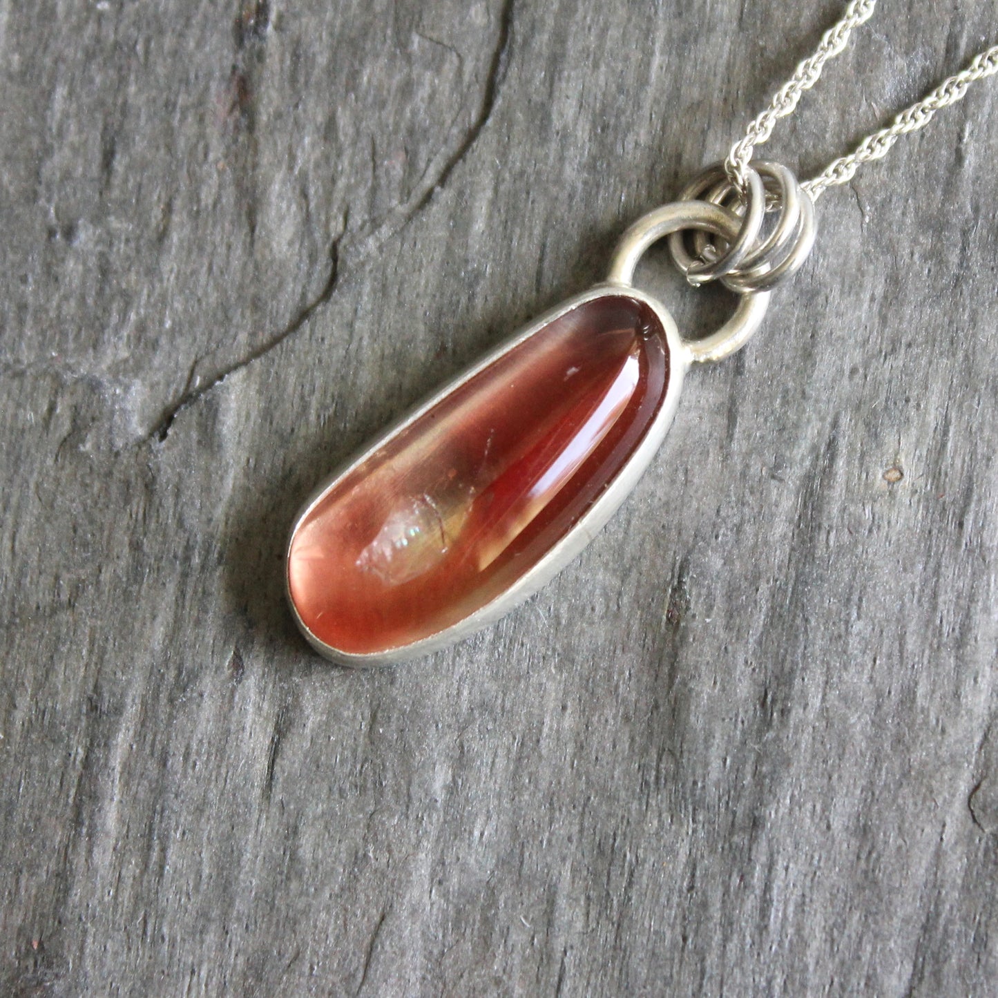 Necklace with an oregon sunstone pendant on a stone surface