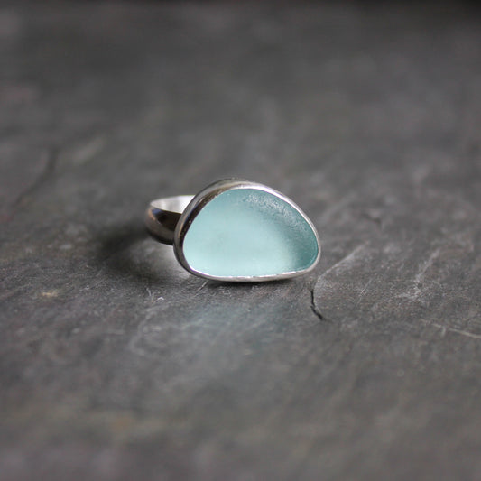 This ring is made with a piece of pale aqua blue sea glass set in a sterling and fine silver bezel on a sturdy silver band.  Size 7 1/2