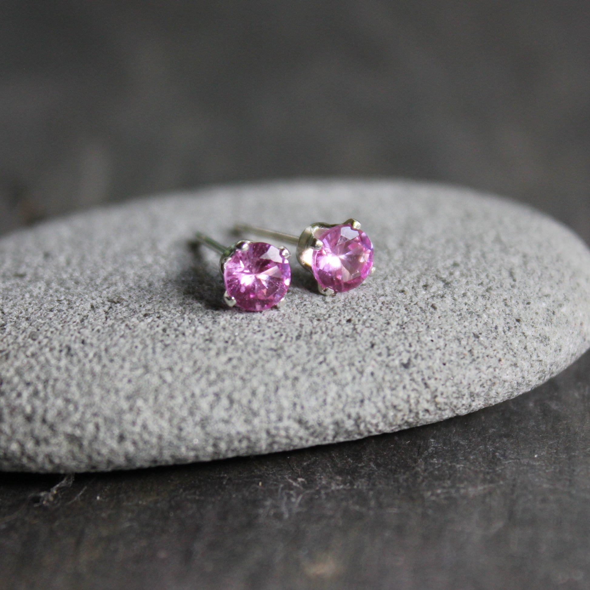 4mm lab created pink tourmaline gemstones set in 4-prong sterling silver stud settings with earring backs. 