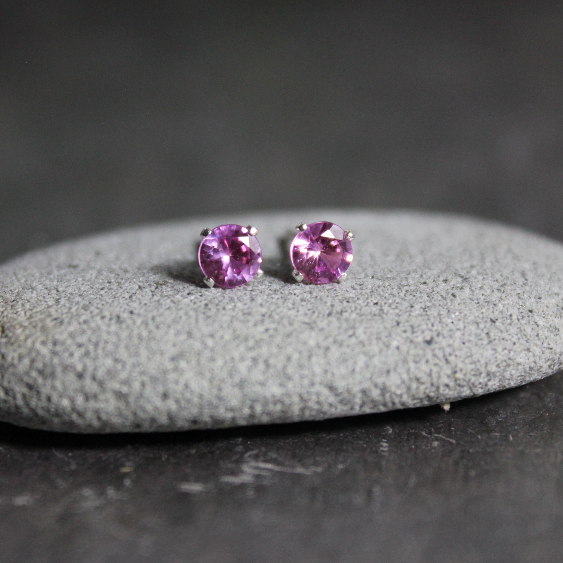 4mm lab created pink tourmaline gemstones set in 4-prong sterling silver stud settings with earring backs. 