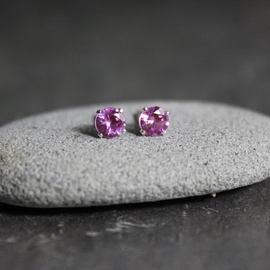 4mm lab created pink tourmaline gemstones set in 4-prong sterling silver stud settings with earring backs. 