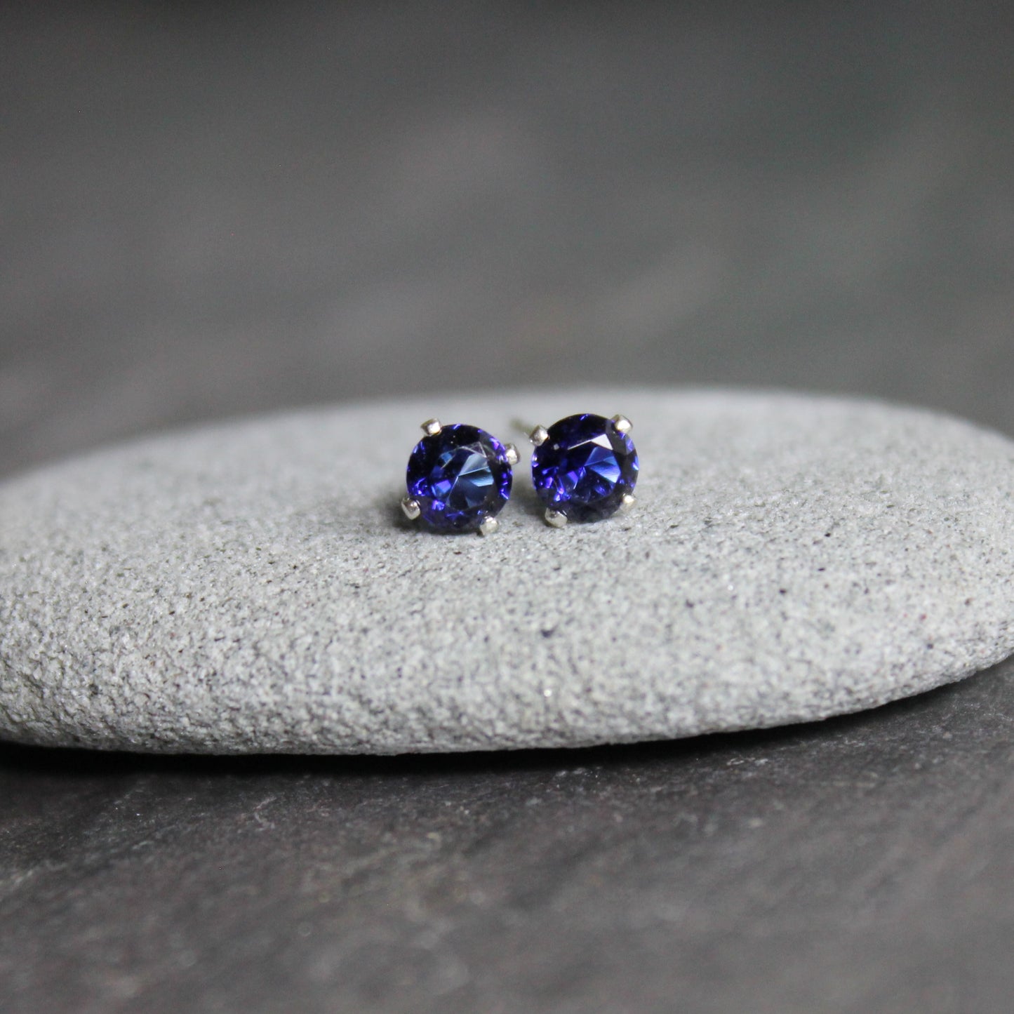 These stud earrings are made with 4mm round faceted lab created sapphires set in 4-prong sterling silver stud earrings with earring backs. 