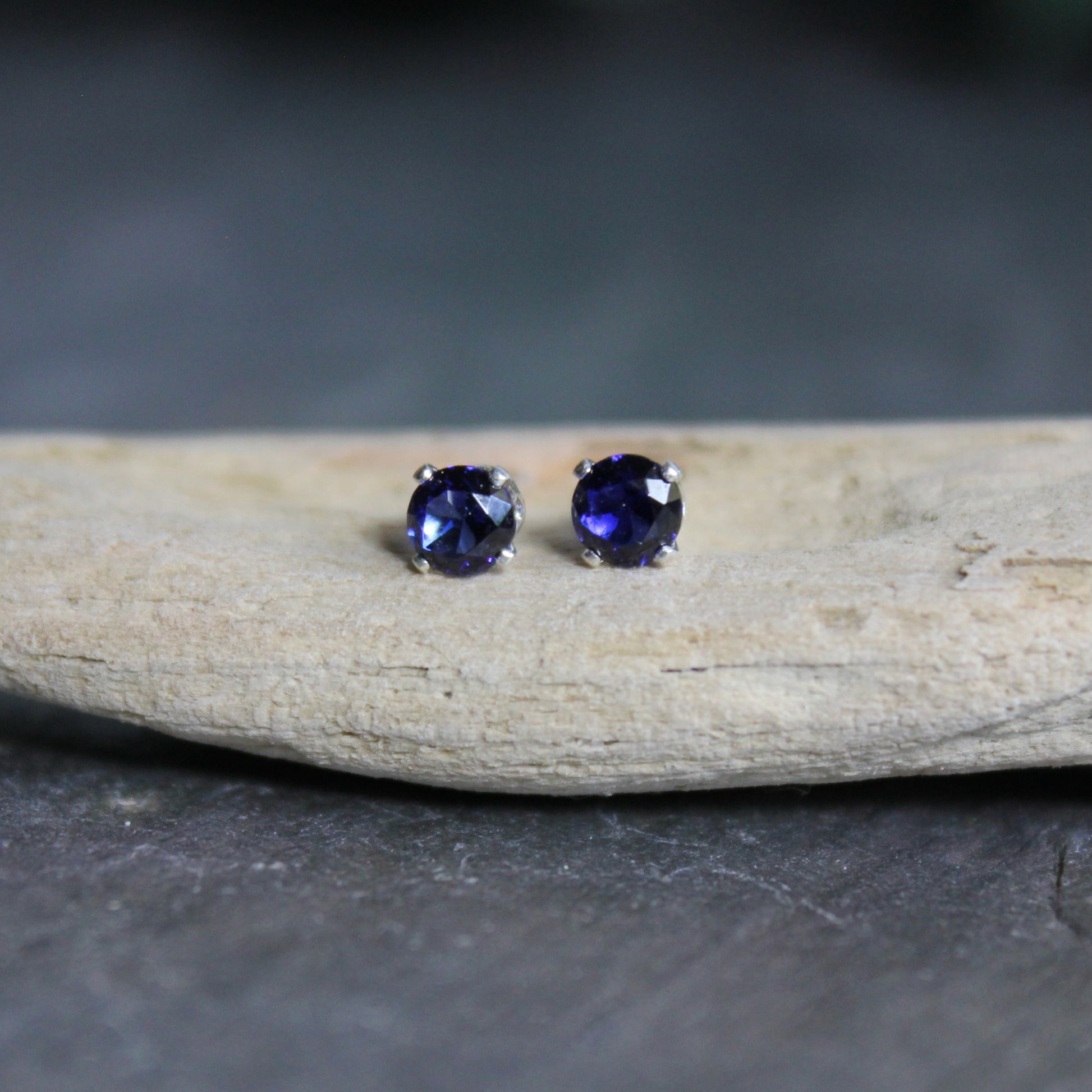 These stud earrings are made with 4mm round faceted lab created sapphires set in 4-prong sterling silver stud earrings with earring backs. 