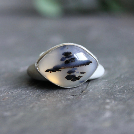 This is a large dendritic Montana agate that is set in a fine & sterling silver bezel setting on a sturdy silver band.  Size 8 1/2